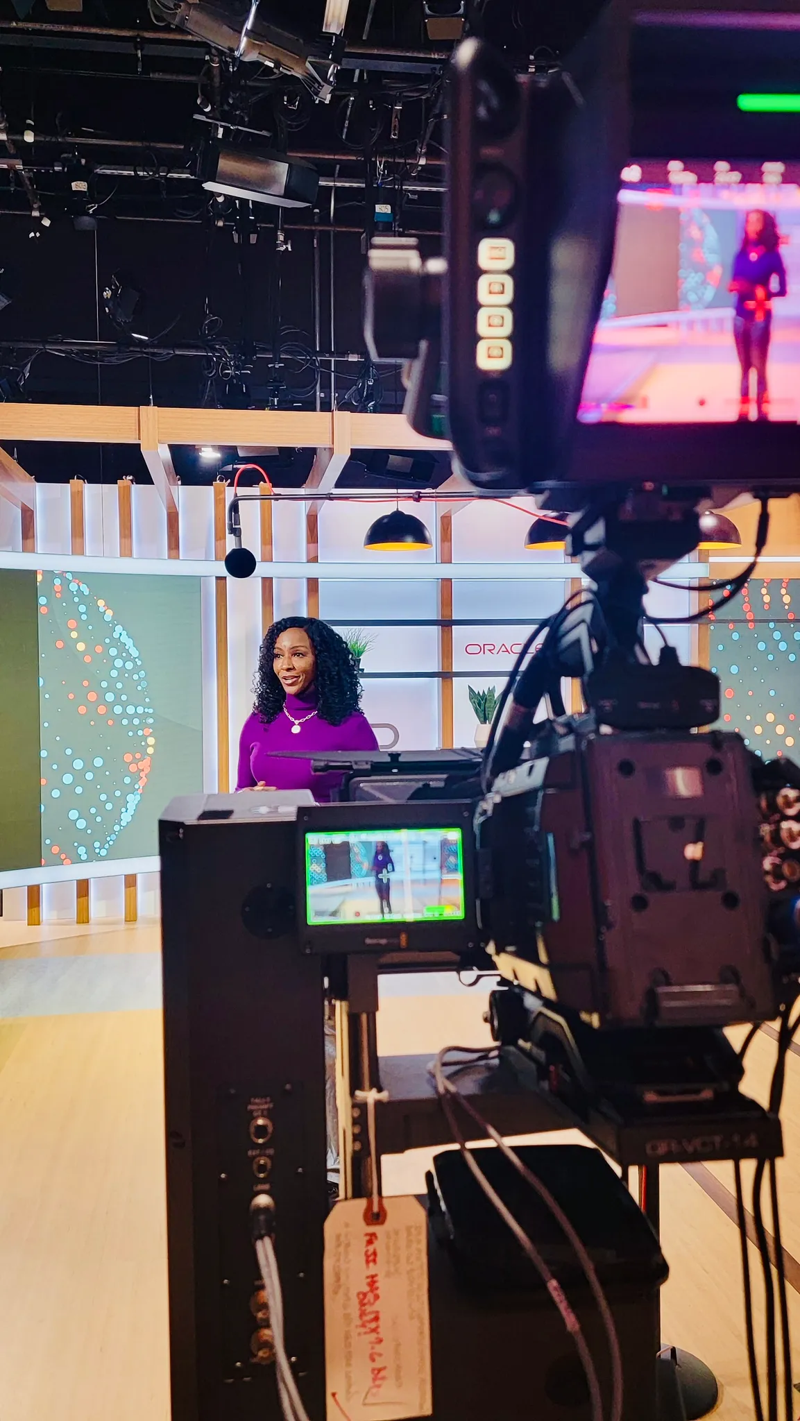 Kay Malcolm on set, seen through the studio camera rig
